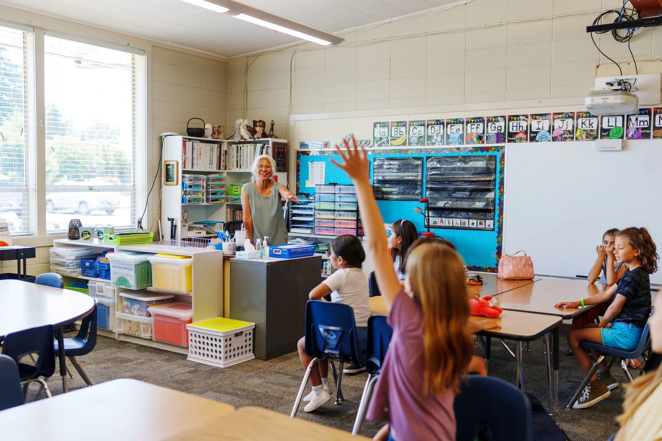 Teacher leading classroom discussion with children