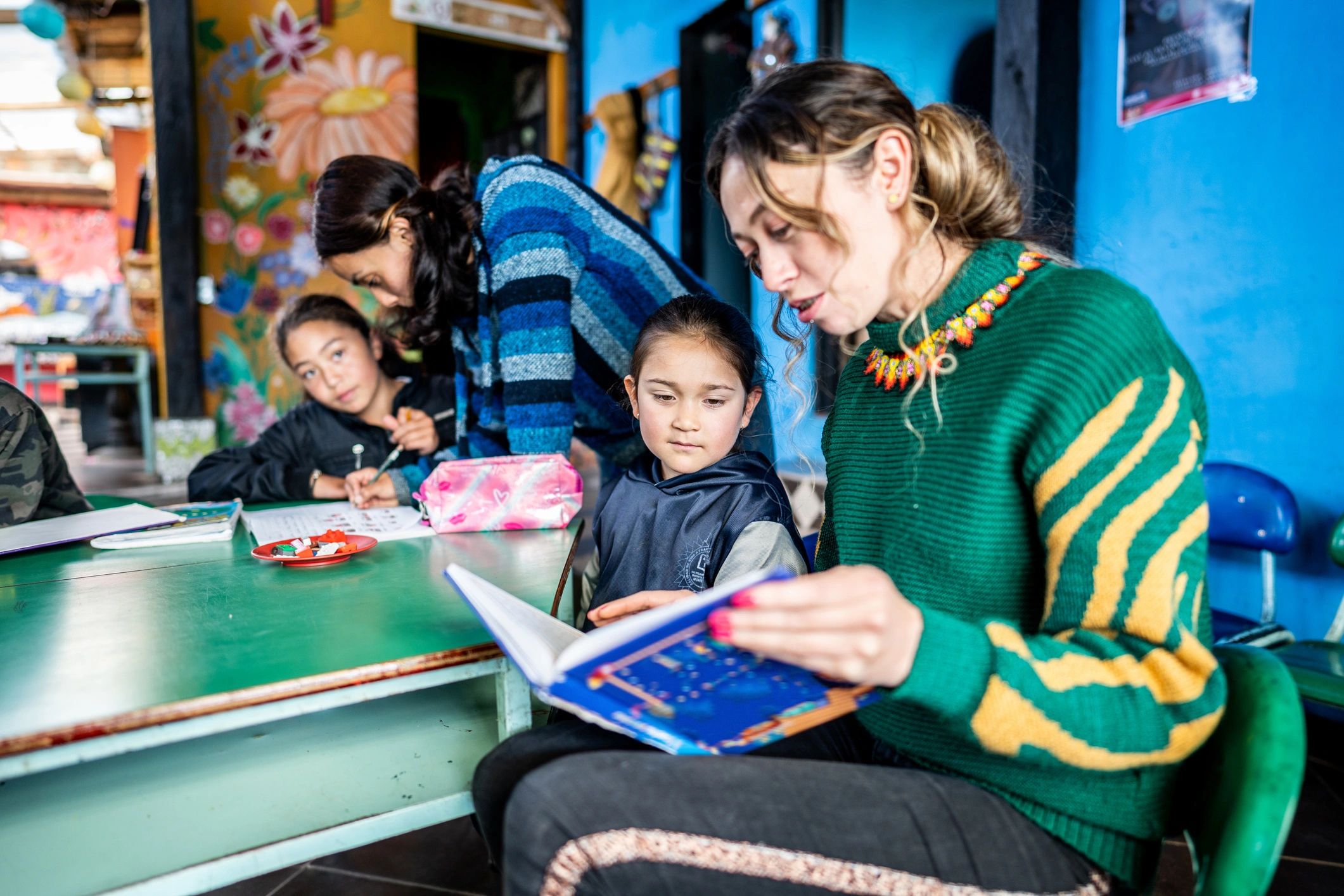 Caregiver reading with children in a childcare setting