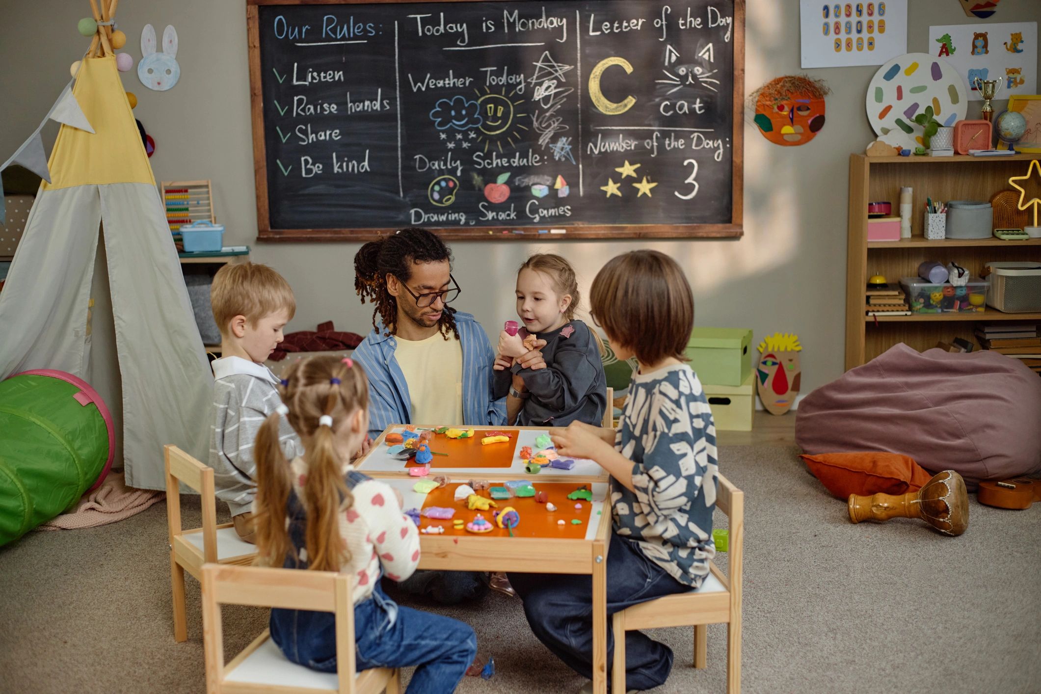 Children creating art together in a warm childcare classroom