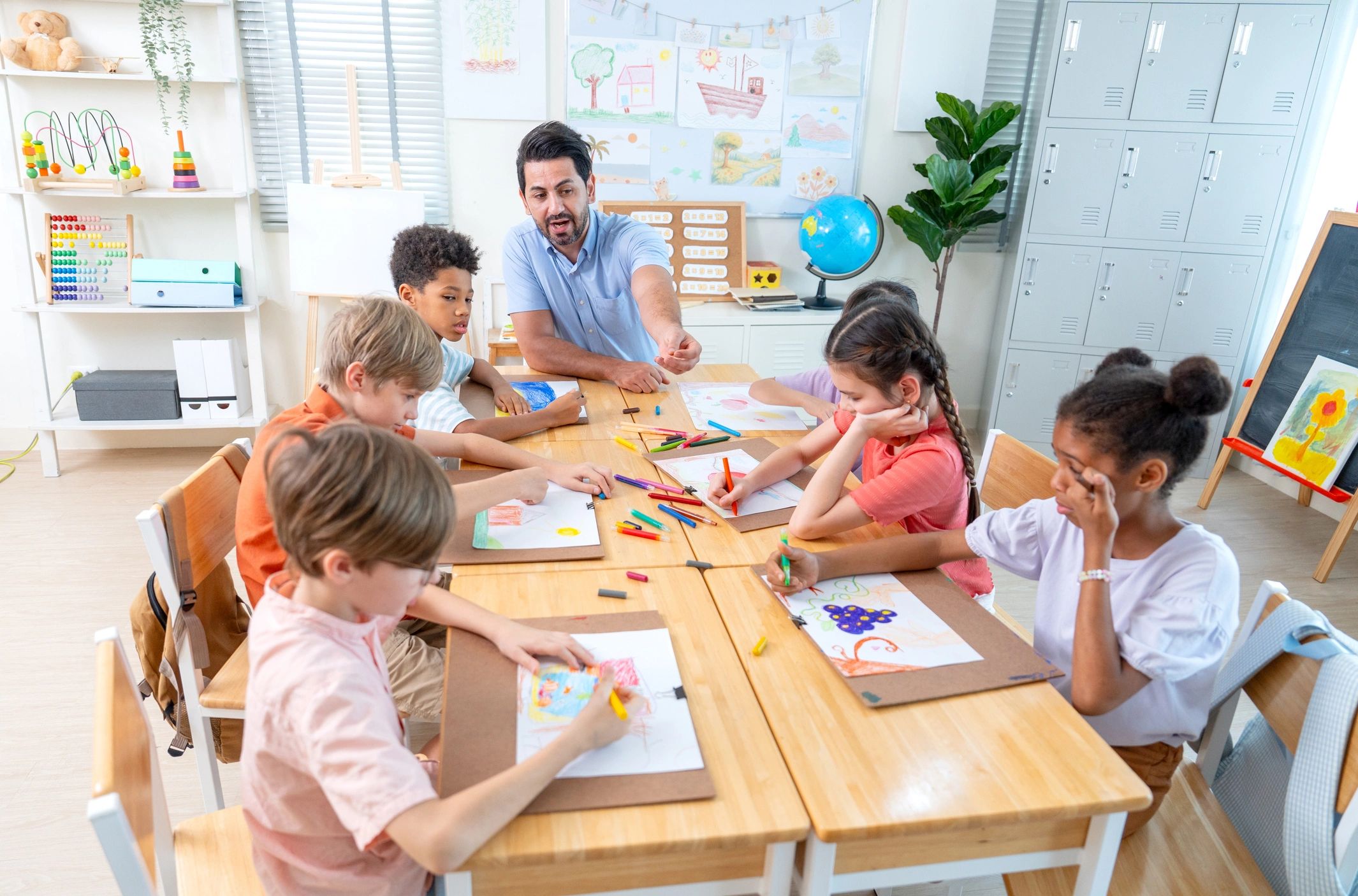 Teacher helping children with art activities